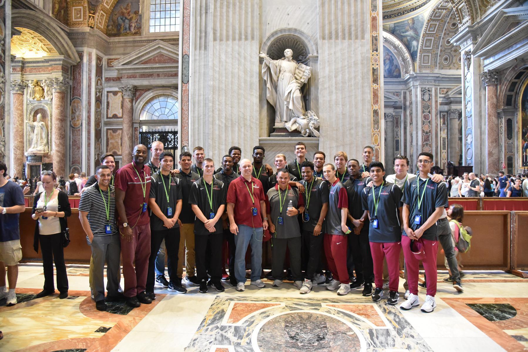 Team in front of Saint Ignatius statue (founders of the Jesuits)